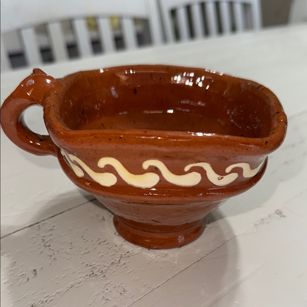 This is an earthenware candlestick, likely of Mexican origin, given the style